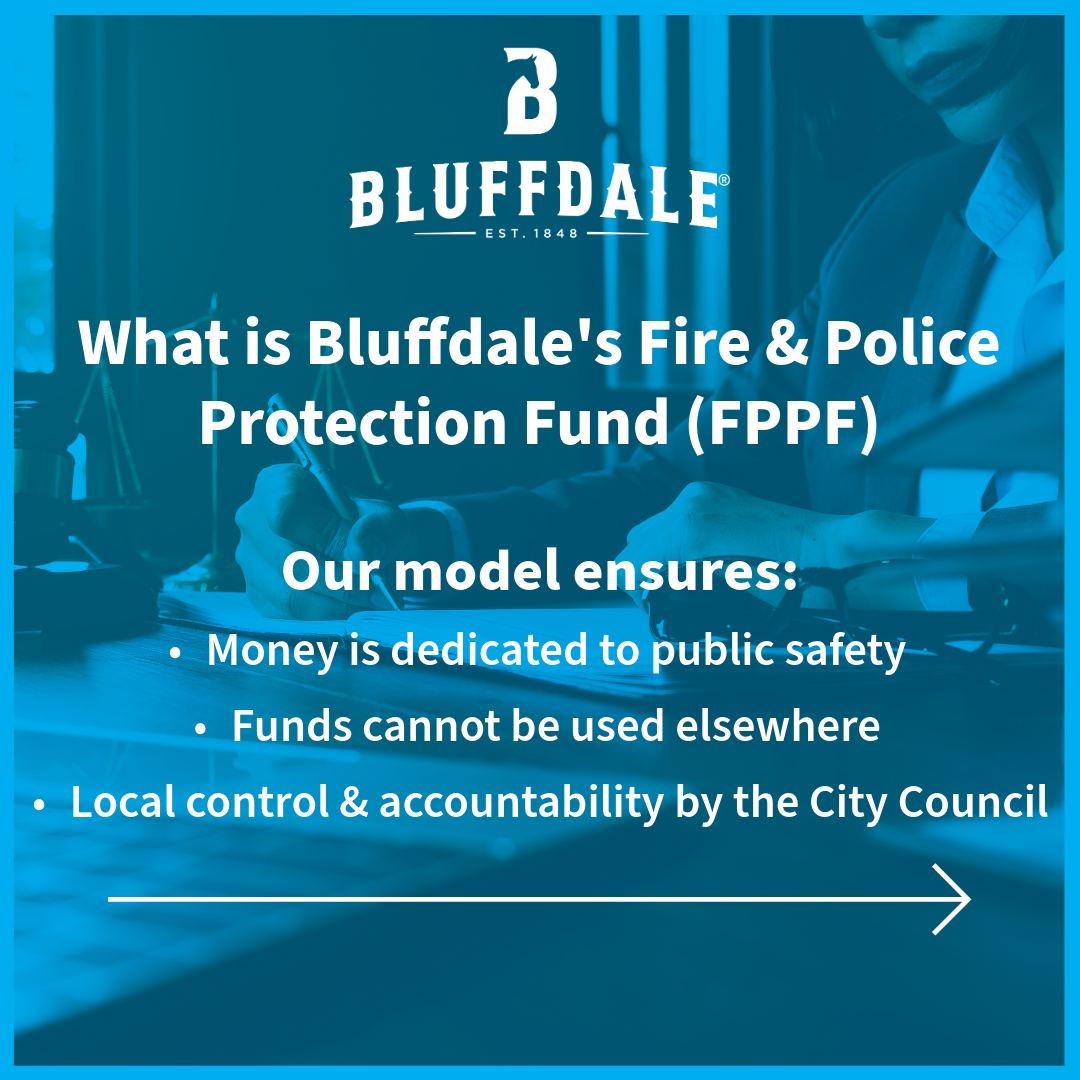 Up close of a person at a desk writing on a stack of papers